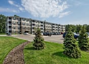 Thumbnail 21 of 35 - an apartment building on the corner of a parking lot at Arbor Ridge, Forest Lake, 55025