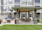 Thumbnail 3 of 35 - a covered patio with a table and chairs at Arbor Ridge, Forest Lake, Minnesota