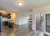 Thumbnail 17 of 35 - a living room and kitchen with a sliding glass door at Arbor Ridge, Forest Lake, Minnesota