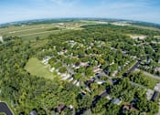 Thumbnail 3 of 16 - a aerial view of a neighborhood of houses and trees and a field