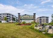 Thumbnail 1 of 31 - a sign for summit apartments with buildings in the background at Summit Ridge, Duluth, MN