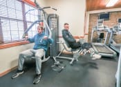Thumbnail 28 of 31 - two men and a dog sitting on the gym equipment at Summit Ridge, Duluth, MN, 55811