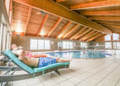 Thumbnail 2 of 31 - a couple of people are laying in a swimming pool at Summit Ridge, Duluth