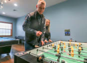 Thumbnail 12 of 31 - two people playing a game of foosball at a table at Summit Ridge, Duluth, MN
