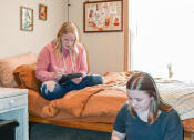 Thumbnail 20 of 31 - two girls sitting on the floor in a bedroom on their laptops at Summit Ridge, Minnesota, 55811