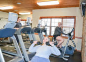 Thumbnail 17 of 31 - three women on exercise machines in a gym at Summit Ridge, Duluth, Minnesota