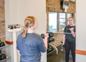 Thumbnail 19 of 31 - a woman taking a picture of herself in a mirror at a gym at Summit Ridge, Duluth
