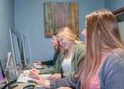 Thumbnail 9 of 31 - three women sitting at a desk working on computers at Summit Ridge, Duluth, MN, 55811