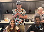 Thumbnail 50 of 67 - a group of people standing in a kitchen holding plates of food  at Timber Ridge, Forest Lake, MN