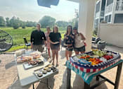 Thumbnail 44 of 67 - a group of people standing around a table with food on it  at Timber Ridge, Forest Lake, MN, 55025