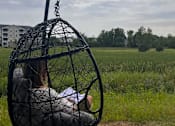 Thumbnail 49 of 67 - a child is sitting in a bird cage on a swing  at Timber Ridge, Forest Lake, MN, 55025