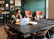 Thumbnail 57 of 67 - a woman sitting at a table with a laptop computer  at Timber Ridge, Forest Lake, 55025