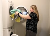 Thumbnail 67 of 67 - a woman doing laundry in a washing machine  at Timber Ridge, Forest Lake, 55025