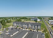 Thumbnail 42 of 67 - an aerial view of a city street with buildings and trees  at Timber Ridge, Minnesota, 55025