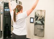 Thumbnail 66 of 67 - a woman standing in a gym with her arms in the air  at Timber Ridge, Forest Lake, MN, 55025