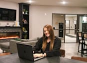 Thumbnail 63 of 67 - a woman sitting at a table with a laptop computer  at Timber Ridge, Minnesota, 55025