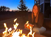 Thumbnail 53 of 67 - a woman sitting in front of a fire pit  at Timber Ridge, Minnesota