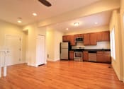 Thumbnail 3 of 13 - a large empty kitchen with wood flooring and