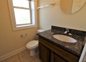 Thumbnail 12 of 13 - a bathroom with a sink and a toilet and a window