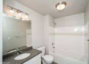 Thumbnail 6 of 25 - a bathroom with a sink toilet and a bath tub