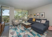 Thumbnail 4 of 61 - Spacious living room with natural lighting and balcony access