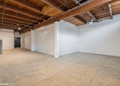Thumbnail 8 of 57 - A large empty room with wooden ceiling and tiled floor.