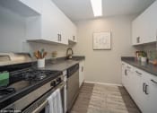 Thumbnail 2 of 61 - Sleek kitchen with a gas top stove