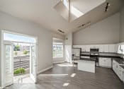 Thumbnail 1 of 25 - an open kitchen and living room with a large glass door