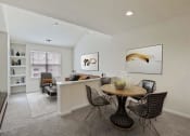 Thumbnail 4 of 20 - A dining room with a round table and chairs.