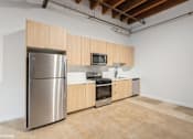 Thumbnail 12 of 57 - A kitchen with wooden cabinets and stainless steel appliances.