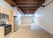 Thumbnail 2 of 57 - A kitchen with wooden cabinets and stainless steel appliances.