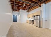 Thumbnail 4 of 57 - A kitchen area with a stainless steel refrigerator, microwave, and oven.