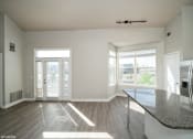 Thumbnail 3 of 25 - an empty living room with a large window and a table