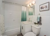 Thumbnail 6 of 61 - Bright bathroom with tub and vanity storage