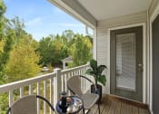 Thumbnail 7 of 20 - A table with a cup and a plant on a porch.