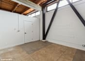 Thumbnail 11 of 57 - A room with a white wall and a brown floor.