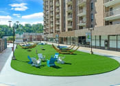 Thumbnail 33 of 82 - Relax in the plaza - bistro seating and hammocks galore at Trillium Apartments, Fairfax, 22031