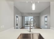 Thumbnail 5 of 42 - A modern kitchen with a stainless steel sink and a large window.