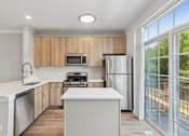 Thumbnail 3 of 48 - Davey Two Bedroom Townhome - renovated kitchen with stainless steel appliances and rich wood cabinetry