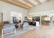 Thumbnail 13 of 20 - a large living room with furniture and a kitchen