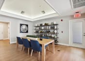 Thumbnail 15 of 20 - a dining room with a wooden table and blue chairs