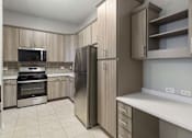 Thumbnail 2 of 42 - A kitchen with a refrigerator, oven, and microwave.