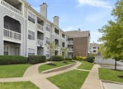 Thumbnail 19 of 20 - Apartment complex with a walkway between the buildings.