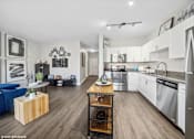 Thumbnail 9 of 29 - A modern kitchen with stainless steel appliances and a wooden island.