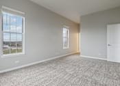 Thumbnail 7 of 42 - A room with a carpeted floor and two windows.