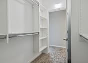 Thumbnail 10 of 42 - A white closet with shelves and a door.