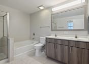 Thumbnail 8 of 42 - A bathroom with a toilet, sink, and shower.
