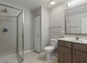 Thumbnail 11 of 42 - A bathroom with a toilet, sink, and shower.
