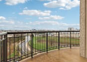 Thumbnail 13 of 42 - A balcony with a metal railing overlooks a baseball field.