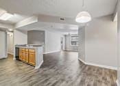 Thumbnail 1 of 40 - Open dining area with modern lighting overlooking the spacious living room and kitchen in a 3-bedroom, 2-bath apartment at Gregory Cove in Jacksonville, FL.